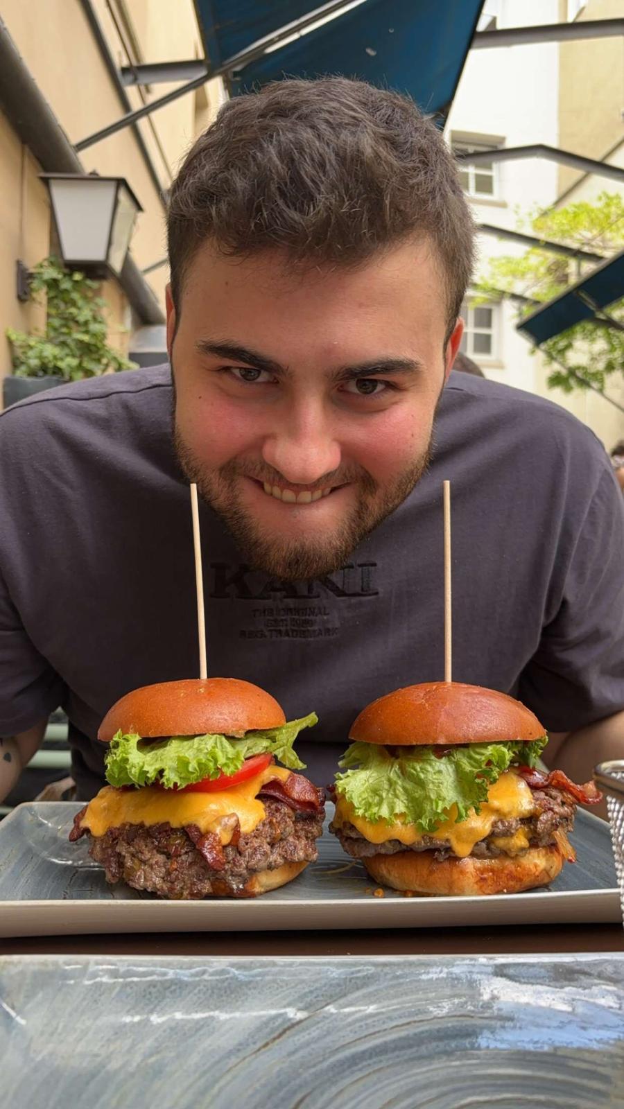 Person eager to eat the two burgers in front of them